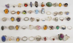 A collection of fifty seven silver rings including lapis lazuli, pressed amber, turquoise, agate,