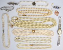 A collection of jewellery including two silver brooches, faux pearls including one with 9ct gold