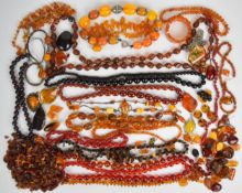 A collection of amber/ amber style and Bakelite necklaces, amber beads, amber pendants, four amber