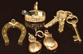 Four 9ct gold charms including keys, champagne bottle in a basket, horseshoe and castanets,  4.6g