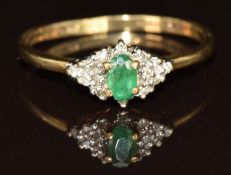 A 9ct gold ring set with an oval cut emerald and diamonds, 2g, size R