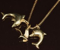 A 14k gold chain, two 14k gold dolphin pendants and a 14k gold seagull pendant, 8.9g, 44cm