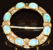 An 18ct gold circular brooch set with eight oval opal cabochons and diamonds, 4.7g, 2.5cm