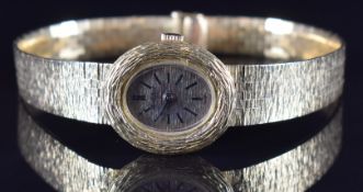 Bueche Girod 18ct gold ladies wristwatch with black hands and baton hour markers and textured gold