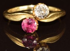 A c1920 18ct gold ring set with a round cut spinel of approximately 0.4ct and an old cut diamond