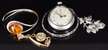 A 9ct gold cased watch, silver brooch, silver bangle set with pressed amber, silver bangle and