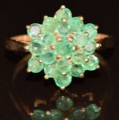 A 9ct gold ring set with a cluster of emeralds, 3.3g, size P