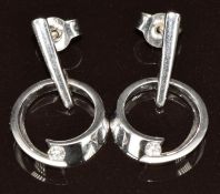 A pair of 18ct white gold earrings each set with a diamond of approximately 0.04ct in a circular