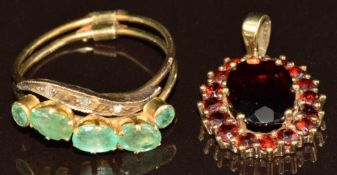 A 9ct gold pendant set with garnets (2.1g) and a yellow metal ring made up of two bands, one set