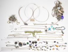 A collection of silver jewellery including twenty-nine necklaces/ chains and pendants, peridot