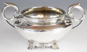 William IV hallmarked silver twin handled sugar bowl with scroll handles and raised on four feet,