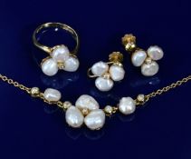 An 18ct gold suite of jewellery comprising necklace, ring and earrings set with blister pearls and