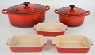 Le Creuset cast iron twin handled casserole dish and saucepan, numbers 20 and 29, together with