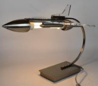 Novelty table lamp in the form of a jet aeroplane with metal stand and body and acrylic wings,