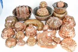 Approximately 25 Victorian and later copper jelly and similar moulds, including fish, diameter of