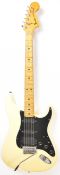 Fender Stratocaster electric guitar in cream finish with maple neck and black scratch plate,