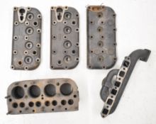 Austin Seven high compression cylinder head, two low compression cylinder heads, manifold and a