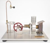 Hot air or Stirling cycle engine, driving a 9.5cm flywheel, with aluminium water jacket and finned