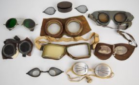 Nine pairs of vintage goggles to include slitted examples, possibly snow goggles or stone mason's,