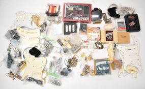 A collection of vintage and modern guitar parts and components comprising pickups, pots, bridges,