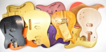 Ten mostly MJT stamped electric guitar bodies in Fender and Gibson styling.