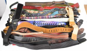 Thirty eight guitar straps comprising leather and canvas examples.