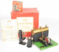 Merit live steam engine with twin oscillating cylinders driving a spoked flywheel, the base having