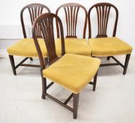 Set of four 19th century upholstered mahogany dining chairs with arch top splat backs, raised on