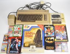 Commodore 64 retro computer together with power supply, cassette deck and games including Robocop,