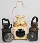 Three railway lamps comprising BR(E) tail lamp and BR(W) and LMS hand lamps, height of tallest 49.