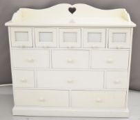 Possibly Dragons of Walton Street white painted chest of drawers with glass fronted photograph