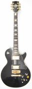 Les Paul style electric guitar in black finish with rosewood fretboard, pearlescent inlays, gold