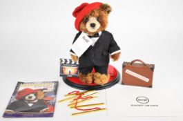 Steiff Paddington at the Premiere teddy bear in tuxedo, with suitcase, clapper board and red
