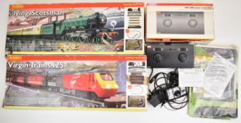 Two Hornby 00 gauge model railway train sets Flying Scotsman and Virgin Trains 125, together with