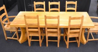 Contemporary oak dining table with concave end supports united with a single stretcher, and eight