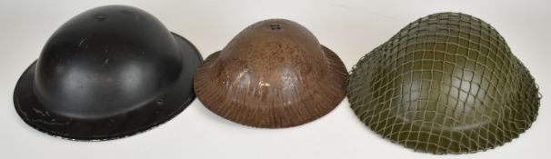 Three British WW2 and post war example helmets comprising child's helmet marked SAP to front,