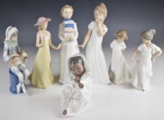 Seven Nao figures including child harlequin, tallest 26cm