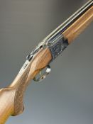 Laurona 12 bore over and under shotgun with engraved scenes of dogs and birds to the locks,
