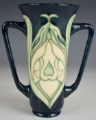 Moorcroft Collector's Club twin handled vase decorated in the Snowdrop pattern, H15cm