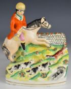 19thC Staffordshire figure of a huntsman with hounds, H20cm