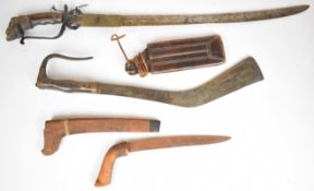 Three Eastern bladed weapons or tools comprising a short sword with ornately carved handle in the