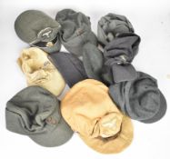 Ten German military style caps and hats, some with insignia or badges added, one cap with printed 'F