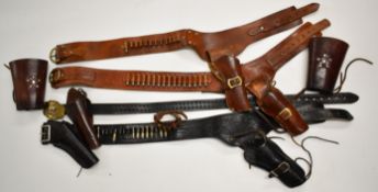 Four leather pistol or revolver holsters and belts, some with inert cartridges together with a