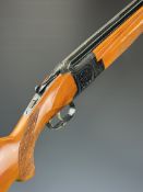 Laurona 12 bore over and under shotgun with engraved scenes of dogs and birds to the locks,