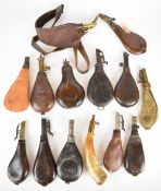 Fourteen various leather and brass shot flasks, some with embossed decoration and some containing