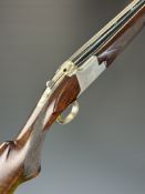 Browning B125 12 bore over and under ejector shotgun with engraved scenes of birds and dogs to the