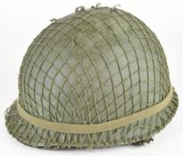 WW2 US M1 steel helmet with netting, swivel bales, separate liner system stamped with Firestone