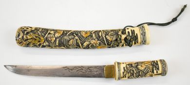 Japanese carved bone Tanto depicting a battle with Samurai Warriors, the blade having engraved