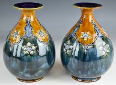 Pair of Royal Doulton art pottery pedestal vases with inscribed potter's marks to bases, H24cm