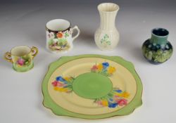 Moorcroft vase decorated with the Blue Leaf and Berry pattern, Clarice Cliff cake plate decorated in